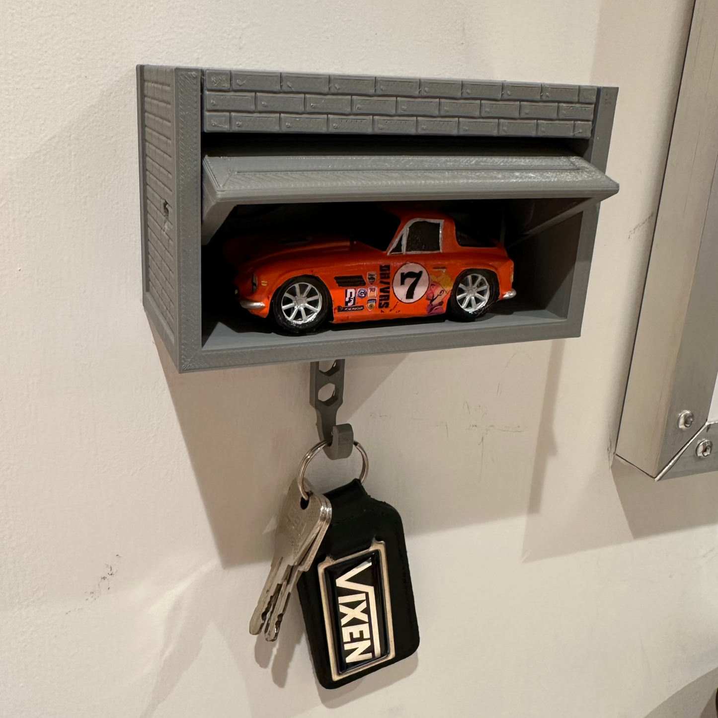 Pop up garage key holder